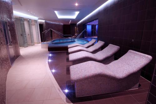 a bathroom with a jacuzzi tub in a building at Parklands Hotel & Country Club in Newton Mearns