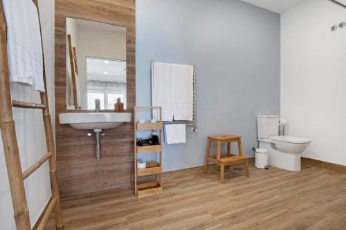 a bathroom with a sink and a toilet and a mirror at Quinta dos Raposos- Nazaré Portugal in Nazaré