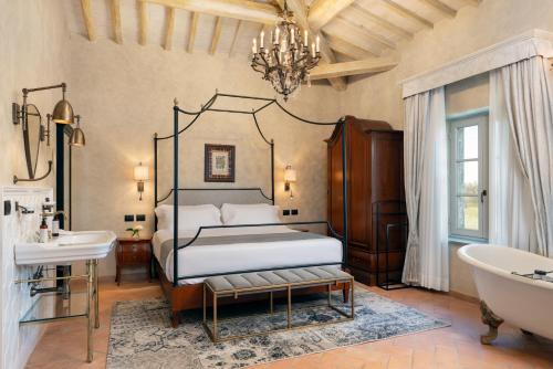a bedroom with a bed and a tub and a sink at Villa Petriolo - Small Luxury Hotels of the World in Cerreto Guidi