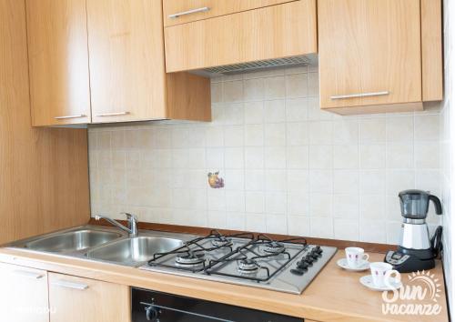 a kitchen with a sink and a stove top oven at Limpiddu in Limpiddu