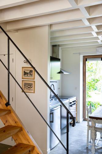 a kitchen with a staircase in a house at Land van Engelingen in Helshoven