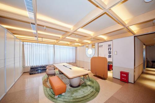 a large room with a table and chairs in it at Orange Hotel Shanghai Hongkou Football Stadium Branch in Shanghai