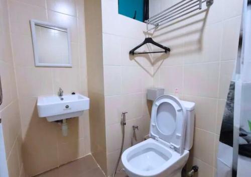 a bathroom with a toilet and a sink at ITCC Manhattan by IGVC in Penampang