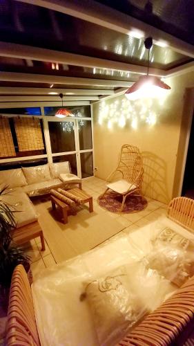 a living room with a couch and chairs and lights at Gîte Gournier's Sweet Home in Bas-en-Basset