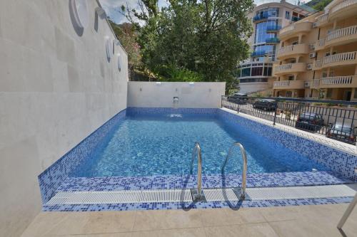 a swimming pool with blue tiles in a building at Villa Katarina in Budva