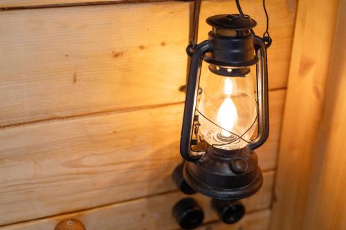 a lantern hanging on a wall with a wooden wall at Müllerleile Hof in Haslach im Kinzigtal