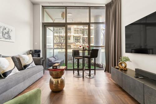 a living room with a couch and a table at FIRST CLASS Studio Urban Hideaway in Dubai