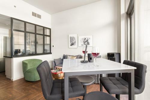 a dining room with a white table and chairs at FIRST CLASS Studio Urban Hideaway in Dubai
