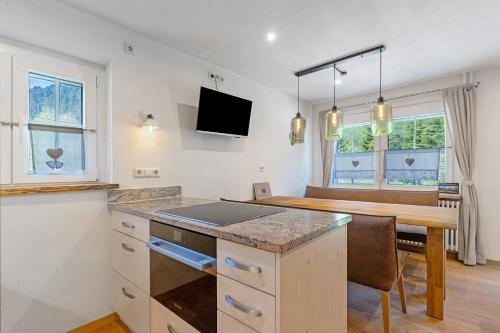 a kitchen with a table and a dining room at Müllerleile Hof in Haslach im Kinzigtal