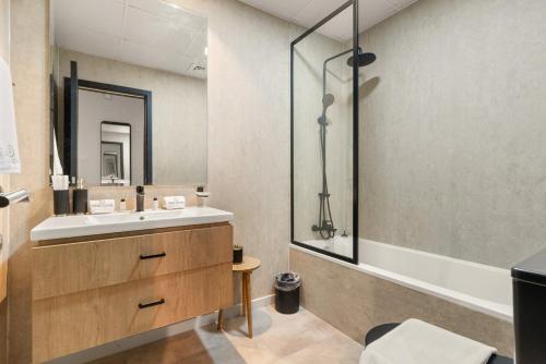 a bathroom with a sink and a bath tub at FIRST CLASS Studio Urban Hideaway in Dubai