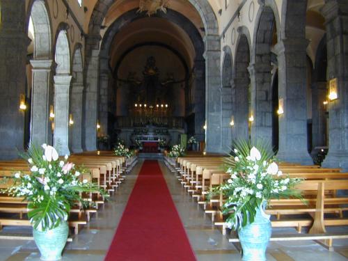 a church with rows of pews and a red carpet at Case Zuccaro in Trecastagni