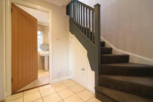 a hallway with a staircase and a stair case at Signature - Cross House in Lanark