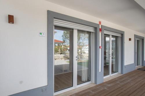 a room with sliding glass doors in a house at Quinta dos Raposos- Nazaré Portugal in Nazaré