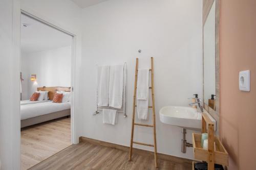 a bathroom with a sink and a mirror and a bed at Quinta dos Raposos- Nazaré Portugal in Nazaré