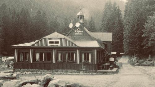 an old photo of a large building in the snow at Horská Bouda v Obřím Dole in Pec pod Snezkou