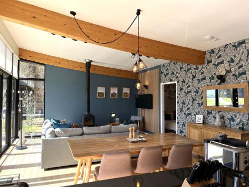 a living room with a table and a couch at Yorkshire Dales Lodge 3 by Together Travel - 3-Bed Family Retreat in Richmond