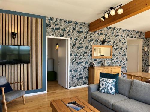 a living room with a couch and a tv at Yorkshire Dales Lodge 3 by Together Travel - 3-Bed Family Retreat in Richmond