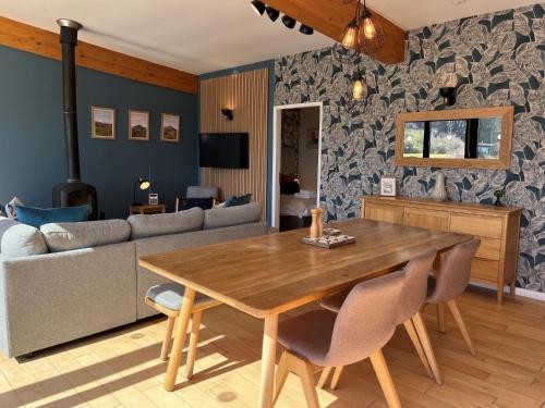 a living room with a wooden table and a couch at Yorkshire Dales Lodge 3 by Together Travel - 3-Bed Family Retreat in Richmond