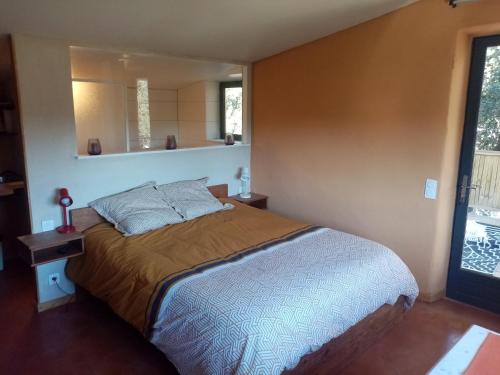 a bedroom with a large bed in a room at Villa Mirabelle in Uzès