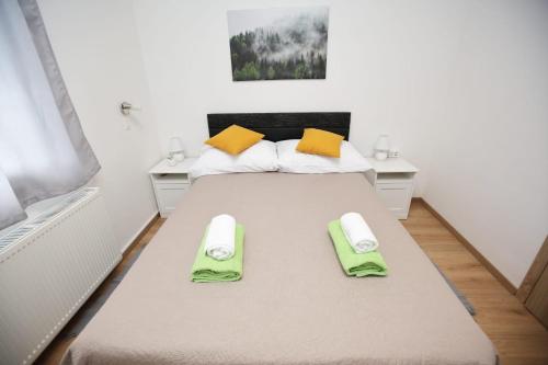 a bedroom with a large bed with two towels on it at Villa Marana in Čavoglave