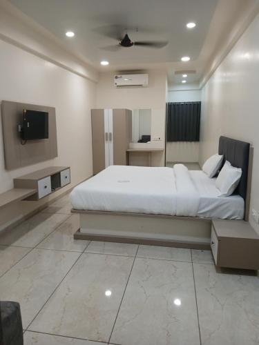 a bedroom with a large bed and a tv at Hotel Radhe Palace in Sārsa