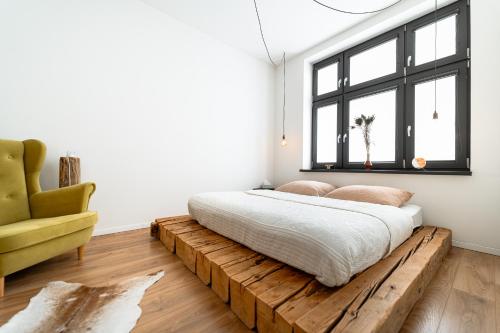 a bedroom with a bed on a wooden platform at The Architects Loft in Košice