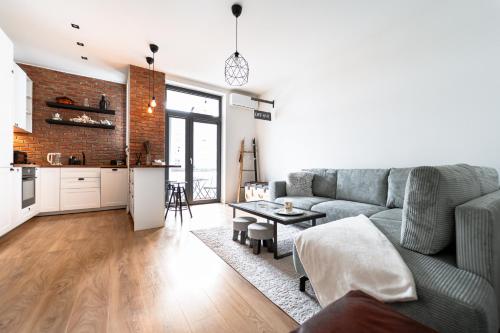 a living room with a couch and a table at The Architects Loft in Košice