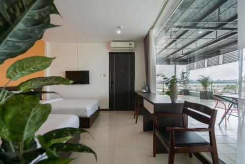 a hotel room with a bed and a desk at COCO Tuan Chau Hotel in Ha Long