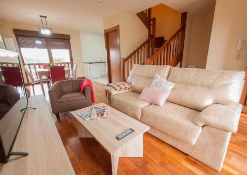 a living room with a couch and a coffee table at La Arcadia de Portillo in Portillo