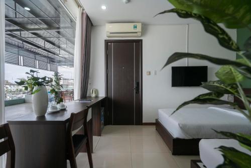a bedroom with a bed and a desk with a desk at COCO Tuan Chau Hotel in Ha Long