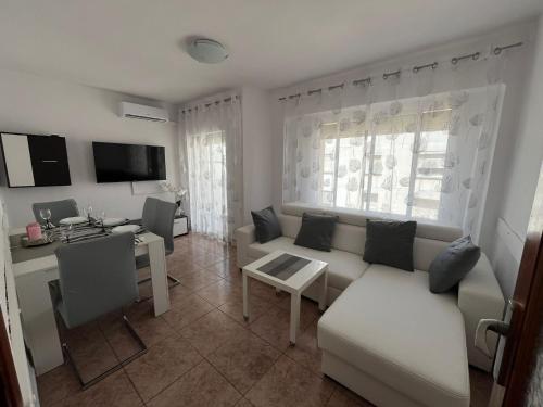 a living room with a couch and a table at Apartament Marina Cullera in Cullera