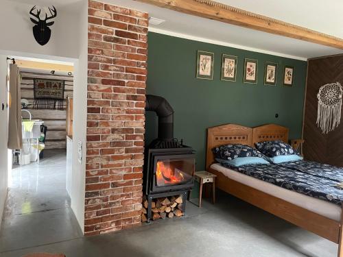 a bedroom with a bed and a fire place at SzareWood in Szare