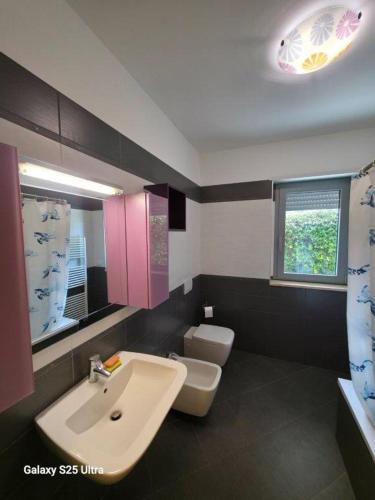 a bathroom with a sink and a toilet at Macrinum - LE DUNE in Silvi Marina