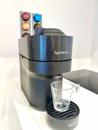 a coffee maker with a glass sitting on a counter at Sissis Paradies Appartement mit Balkon & Flussblick- Das Alpenzeit im Zentrum mit Parkplatz in Bad Aussee