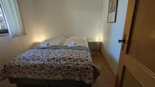 a bedroom with a bed with two pillows on it at Pension Bergblick in Ruhpolding