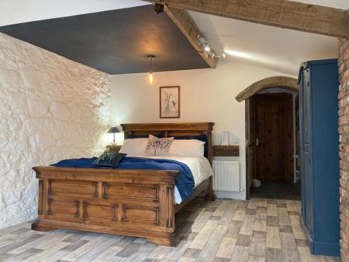 a bedroom with a bed with a wooden dresser at Mill River Retreat in Castlerock