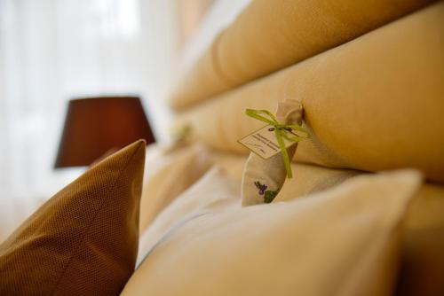 a close up of a bed with pillows at Prónay-kastély in Alsópetény