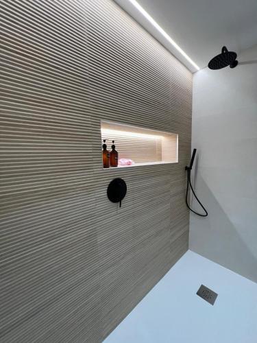 a room with two bottles on a wall with a window at Apartamentos Titus Decimus in Mérida