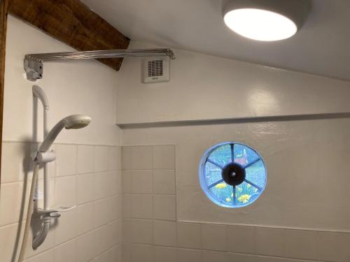 a bathroom with a window in the shower at Mill River Retreat in Castlerock