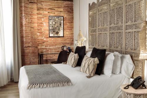 A bed or beds in a room at Hotel La Casa de Los Mosaicos