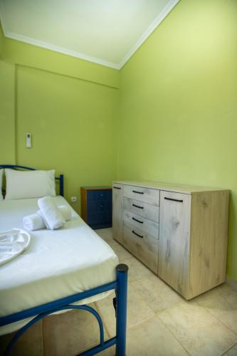 a bedroom with a bed and a wooden cabinet at Minty Home by RentalsPro - Nea Flogita Halkidiki in Flogita