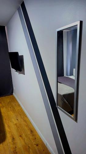 a room with a mirror and a room with a bed at Hotel Delisa in Berlin