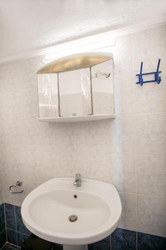 a bathroom with a white sink and a mirror at Minty Home by RentalsPro - Nea Flogita Halkidiki in Flogita