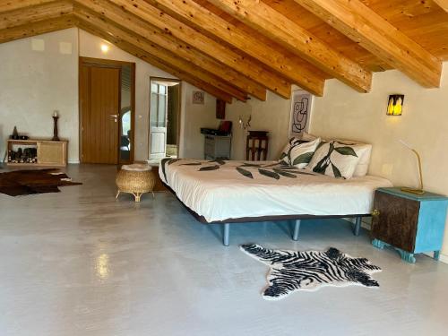 a bedroom with a bed and a zebra rug on the floor at B&B Masia Katmandú in Cretas