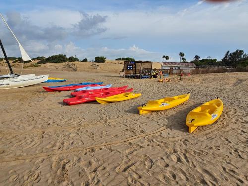 a group of kayaks lined up on a beach at Mary Holiday Home in Ispica