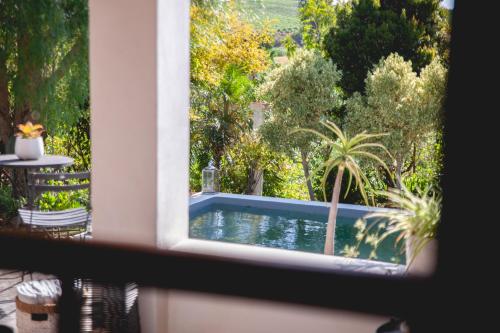 a view of a swimming pool through a window at Croxley Farm in Robertson