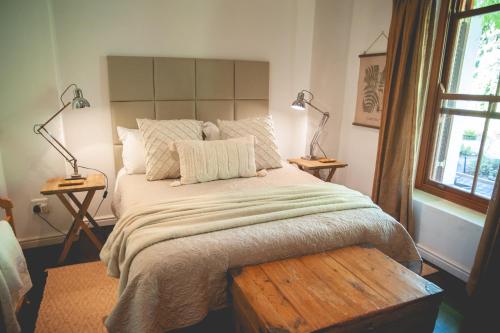 a bedroom with a large bed with two lamps at Croxley Farm in Robertson