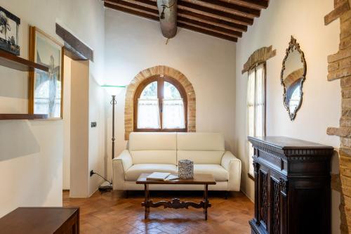 a living room with a couch and a table at Tenuta Tegolato in Barberino di Val dʼElsa