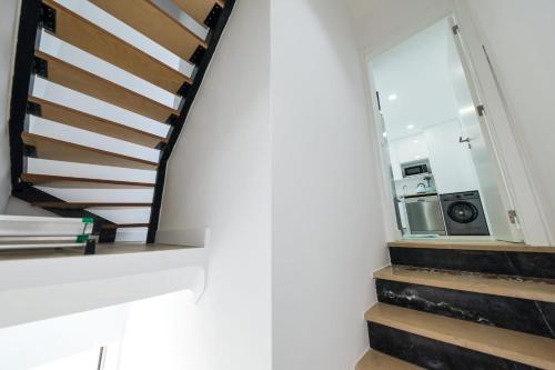 a staircase in a house with a window at Casinha da Rosa in Nazaré