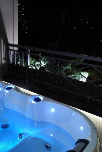 a blue bath tub in a room with a window at SkySpa Apartments - апартаменти з джакузі на терасі з видом на Печерськ in Kyiv